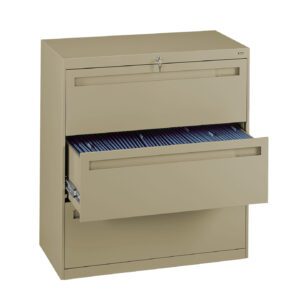 A beige metal filing cabinet with two sliding drawers, one of which is partially open showing hanging blue file folders inside. The cabinet has a lock on the top drawer.