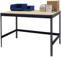 A workbench with a light-colored wooden top and black metal frame. It holds two blue stackable trays, a small printer, an open cardboard box, and a few scattered items including a roll of labels and a black ink pad.