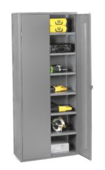 A tall, gray metal storage cabinet with one door open, revealing five shelves. The shelves hold various tools and items, including hard cases, power drills, a helmet, and other equipment. The cabinet has a simple, industrial design.
