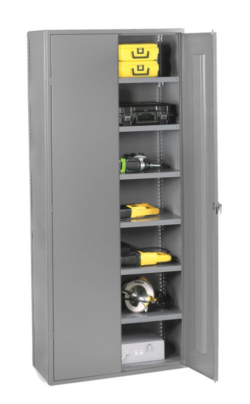 A tall, gray metal storage cabinet with one door open, revealing five shelves. The shelves hold various tools and items, including hard cases, power drills, a helmet, and other equipment. The cabinet has a simple, industrial design.