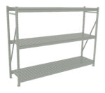 A metal storage rack with three shelves. The structure is light gray and has vertical and horizontal beams with open slatted surfaces. Its designed for heavy-duty use, typically found in warehouses or garages.