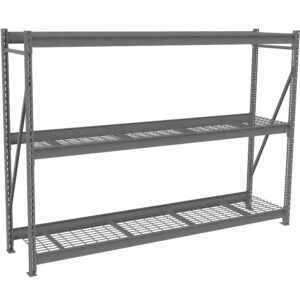 A large, industrial metal shelving unit with three levels. The shelves are made of a grid-like mesh surface, supported by sturdy metal beams. The structure is gray and designed for heavy-duty storage use in warehouses or garages.