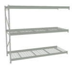 Metal shelving unit with three shelves. The top shelf is a solid metal panel, while the middle and bottom shelves have a grid design. The shelving is light gray and appears sturdy, suitable for storage in a garage or warehouse.