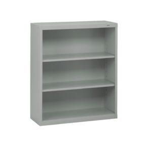 A light gray metal bookshelf with three adjustable shelves. The design is simple and utilitarian, suitable for office or home use. The bookshelf is empty and stands against a plain white background.