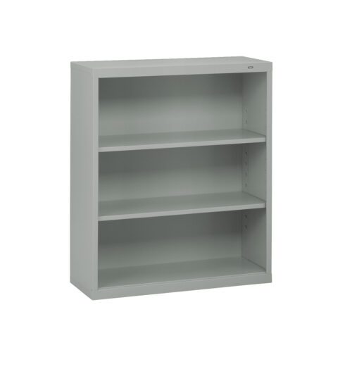 A light gray metal bookshelf with three adjustable shelves. The design is simple and utilitarian, suitable for office or home use. The bookshelf is empty and stands against a plain white background.