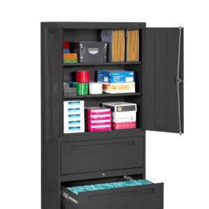 A black office storage cabinet with two upper doors open, revealing various supplies like folders, paper stacks, and boxes. Below, two drawers are partially opened, with the bottom drawer holding hanging file folders.