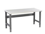 Metal workbench with a light gray rectangular tabletop and sturdy dark gray legs. The legs are adjustable, featuring slotted holes for height modifications. The design is simple and functional, suitable for industrial or workshop settings.