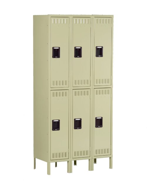 A beige metal locker unit with six compartments arranged in two vertical columns. Each locker has a ventilation grille at the top and bottom, and a black handle in the center. The unit stands on raised legs.