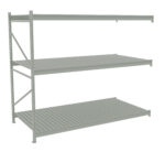 A metal warehouse shelving unit with three adjustable shelves. The design is industrial, featuring a light gray finish and sturdy support beams. The shelves are evenly spaced with a slatted surface.