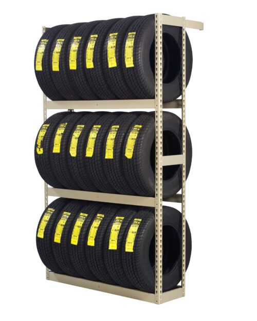 fyc5tojxwvhymqdu4rwl.jpg A shelving unit holds three rows of tires, each labeled with yellow tags. The tires are neatly organized and stacked, indicating a storage or retail display. The shelving is a simple metal frame structure.