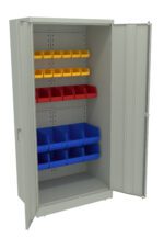 A gray metal storage cabinet with open doors revealing three shelves. The top shelf has yellow bins, the middle shelf has red bins, and the bottom shelf has blue bins. The cabinet is empty except for the bins.