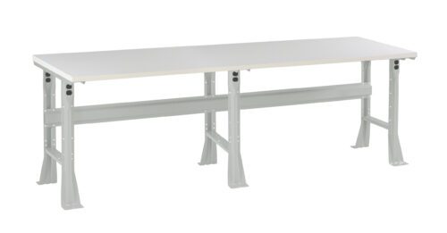 A long, rectangular, industrial-style workbench with a smooth, light gray tabletop and sturdy steel legs. The structure includes a horizontal support beam underneath. The design is simple and functional for workshops or labs.