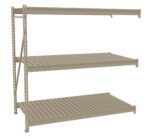 Metal shelving unit with three beige slatted shelves. The structure is supported by vertical beams and appears industrial, suitable for storage or organizational purposes. The shelves are evenly spaced and attached to a freestanding frame.