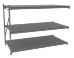 Three-tiered, gray metal shelving unit with slatted surfaces, shown in perspective view. The shelves are evenly spaced and supported by vertical metal beams with cross braces for stability.