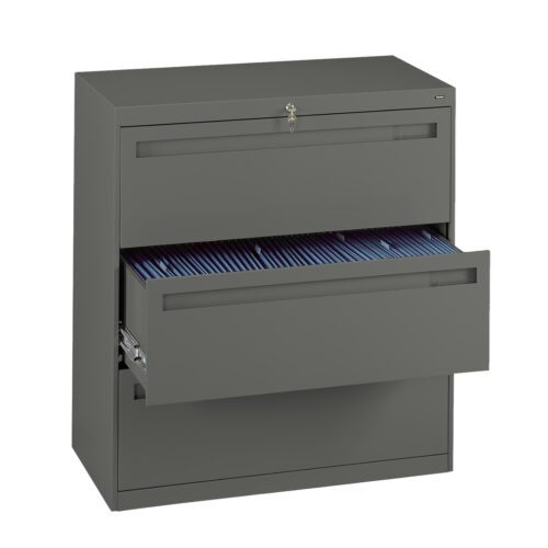 A gray metal filing cabinet with two drawers. The top drawer is closed and the bottom drawer is partially open, revealing blue hanging file folders inside. A lock with a key is visible on the top drawer.