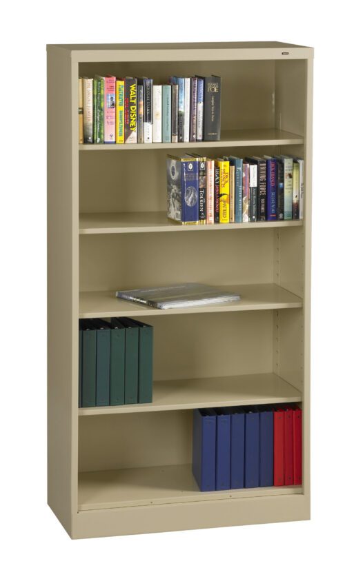 A beige metal bookshelf with five shelves. The top three shelves hold various books, arranged upright and stacked. The bottom two shelves contain binders in green, blue, and red. A single magazine lies on the middle shelf.