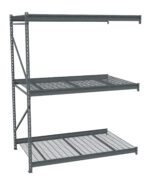 A gray metal shelving unit with three shelves. The top and middle shelves have solid surfaces with perforated patterns, while the bottom shelf features a grid design. The unit is freestanding with a simple, industrial design.