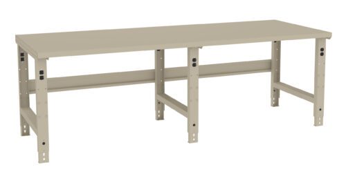 k4fekgtzrgwvyslk3vws.jpg A beige, heavy-duty workbench with adjustable metal legs and a flat rectangular surface. It has a sturdy frame and is designed for industrial or workshop use.