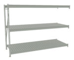 A gray metal shelving unit with three horizontal shelves and a side support structure. The shelves have a slatted design and are positioned parallel to each other for storage purposes.