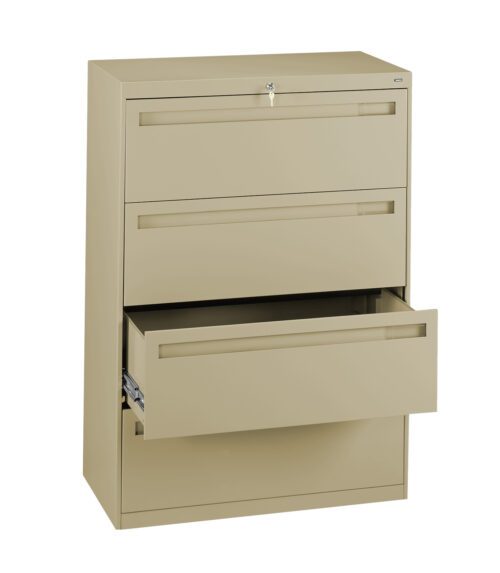 k7hahm03v54a34bkaiik.jpg A beige metal filing cabinet with three drawers is shown. The top two drawers are closed, and the bottom drawer is partially open, revealing its depth. The cabinet has a lock on the top drawer.