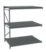 A gray metal industrial shelving unit with three tiers. The shelves are evenly spaced, featuring a slatted design. The unit is structured with vertical support beams on each side.