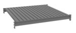 Illustration of a flat, rectangular, gray roof panel with vertical ridges and edges featuring interlocking channels at the sides, designed for construction or architectural use.