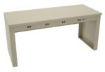 A minimalist beige desk featuring a rectangular top with four round black cable management holes and a slim, extended base on the right side. The desk has a sleek, modern design without drawers or additional features.
