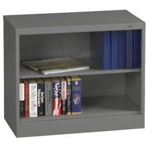 A gray metal bookshelf with two shelves. The top shelf holds three blue binders and a book with a landscape cover. The bottom shelf features seven books, including titles like The Lord of the Rings and The Vampire Chronicles.