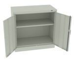 Open gray metal cabinet with two doors and two shelves. The shelves are empty, and the doors are wide open, revealing the interior of the cabinet. The cabinet is placed against a plain background.