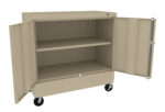 A beige metal storage cabinet on wheels is open, showing two shelves inside. The cabinet has two doors that open outward, revealing empty shelving space.