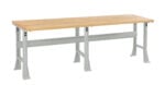 A wooden workbench with a light wood tabletop and sturdy, gray metal legs. The bench has a minimalist design and is isolated on a white background.