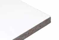 Close-up of the corner of a rectangular, white particle board used in Jaken Material Handling. The edges reveal the layered texture, while the surface is smooth and even against a plain white background.