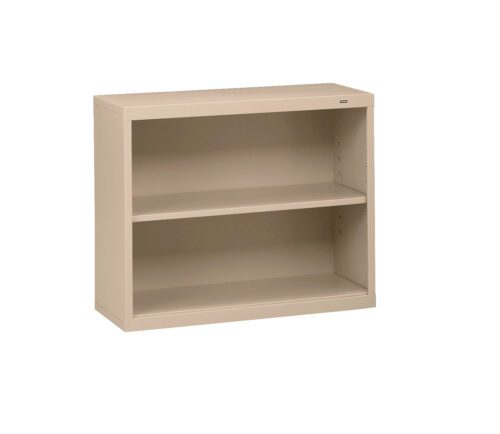 mhqc5wrzis3s9gb2mx1y.jpg A beige metal bookcase with two shelves and a simple, rectangular design. The shelves are adjustable, allowing for flexible storage options. The bookcase is placed against a plain white background.