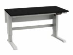 A black rectangular desk with a white adjustable frame and sturdy legs is expertly crafted for optimal ergonomics, ideal for lab design on a white background.
