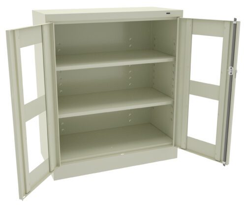 mvm95secaamu1wnqouiw.jpg A beige metal cabinet with two open glass doors and three empty shelves. The cabinet is standing upright, and the interior is visible.