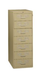 A beige, six-drawer filing cabinet with silver handles and label slots. The cabinet is upright and closed, with a keyhole on the top right. Its positioned against a plain white background.