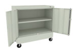 A light gray metal storage cabinet on wheels with both doors open, revealing two shelves inside. The cabinet is designed for storing items securely and can be easily moved.