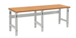 A sturdy workbench with a wooden top and adjustable metal legs. The frame is light grey, and the design is minimalistic and functional, suitable for workshops or garages.