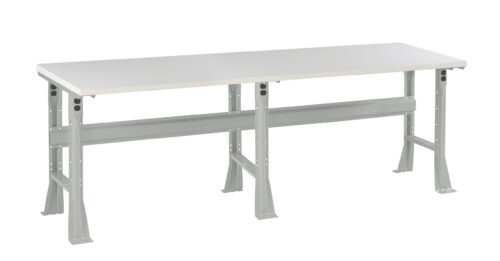 o7vvbaerufbbrhfltqo2.jpg A long, rectangular white table with a sturdy, light gray metal frame and four angled legs. The design is simple and functional, suitable for various purposes like workspaces or utility areas.