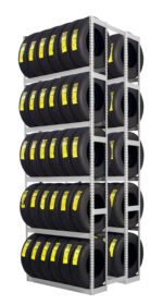A metal rack filled with multiple rows of stacked black tires, each labeled with a yellow tag, arranged neatly in a storage space.