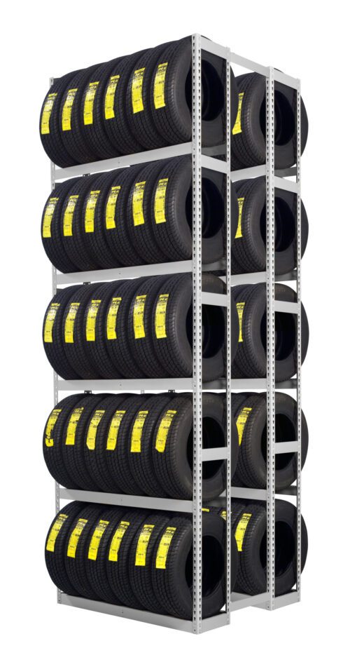 A metal rack filled with multiple rows of stacked black tires, each labeled with a yellow tag, arranged neatly in a storage space.