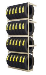 A metal rack displays three rows of stacked black tires, each with a yellow label. The rack is beige, and each row holds multiple identical tires, organized neatly against a white background.
