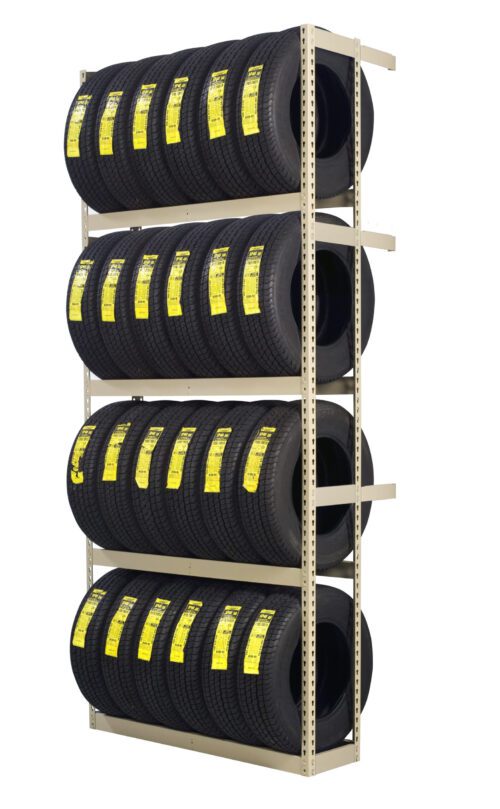 A metal rack displays three rows of stacked black tires, each with a yellow label. The rack is beige, and each row holds multiple identical tires, organized neatly against a white background.