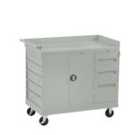 A light gray tool cart with two swivel wheels and two fixed wheels. It features a flat work surface, a central lockable cabinet, three drawers on the right, and six small drawers on the left.