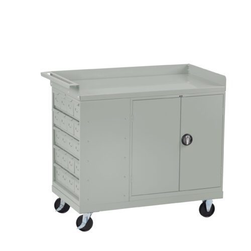 oxb0i5gehgzgtzmeahic.jpg Gray metal utility cart with lockable doors and multiple drawers on the left side. It has a flat top surface and four wheels for mobility. The design is simple and functional, suitable for storage and transport of tools or supplies.