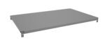 A flat, rectangular, and gray metal panel, possibly a shelf, is shown. It has small holes and brackets on the sides for mounting. The perspective is angled slightly from above, highlighting its thin profile.