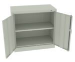 Open metal storage cabinet with two doors and an interior shelf. The cabinet is light gray, with adjustable shelving slots on the sides. The doors are wide open, revealing an empty interior. The cabinet has a plain, functional design.