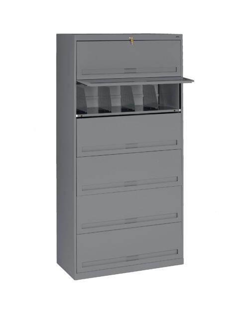 A tall, gray metal filing cabinet with multiple drawers, one of which is open revealing interior compartments. The cabinet features a lock at the top for security.