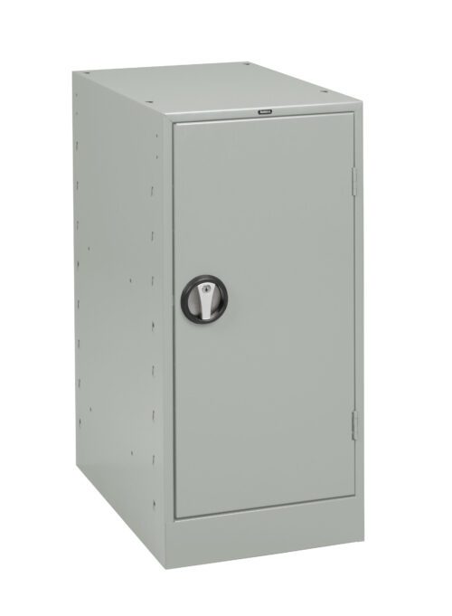 qrsehv6rtzite1zo7ozc.jpg A gray metal locker with a single door is seen in the image. It has a black circular handle for opening and appears to be freestanding with a simple, unadorned design.