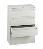 A beige, three-drawer filing cabinet with the bottom drawer open. It has a modern, minimalist design, and a lock at the top. The drawers have sleek horizontal handles.